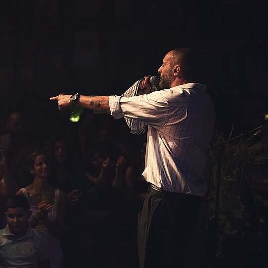 Tamer Nafar giving a concert.
